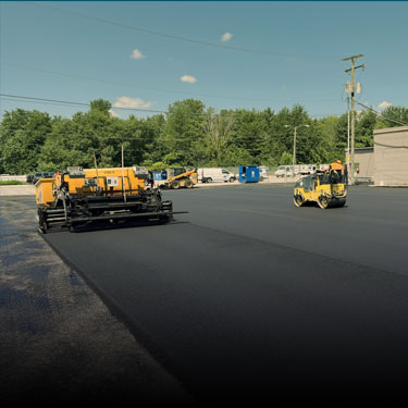 Asphalt paving crew laying fresh blacktop